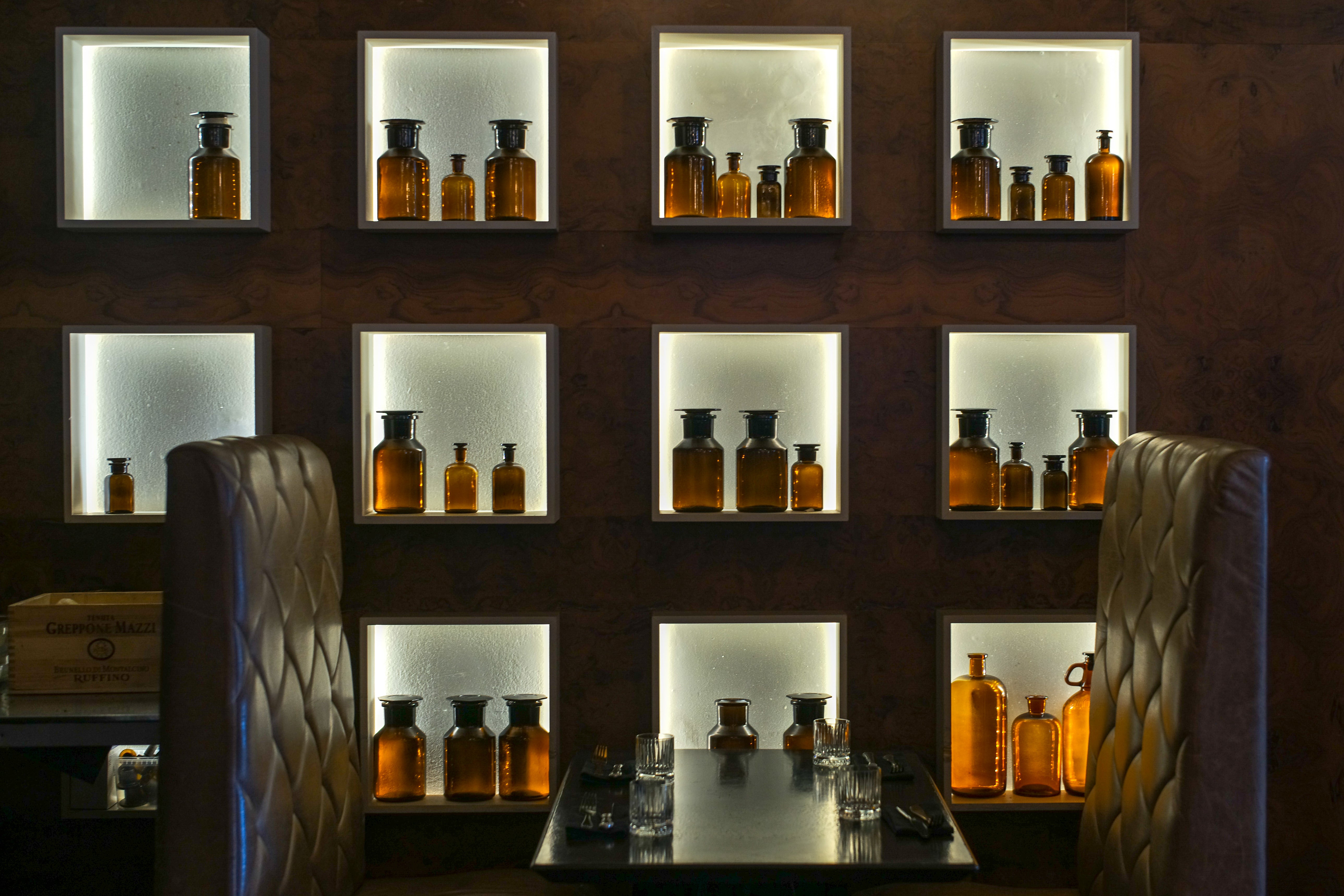 Apothecary Bottles in Lit Niches - Interior Detail Photography