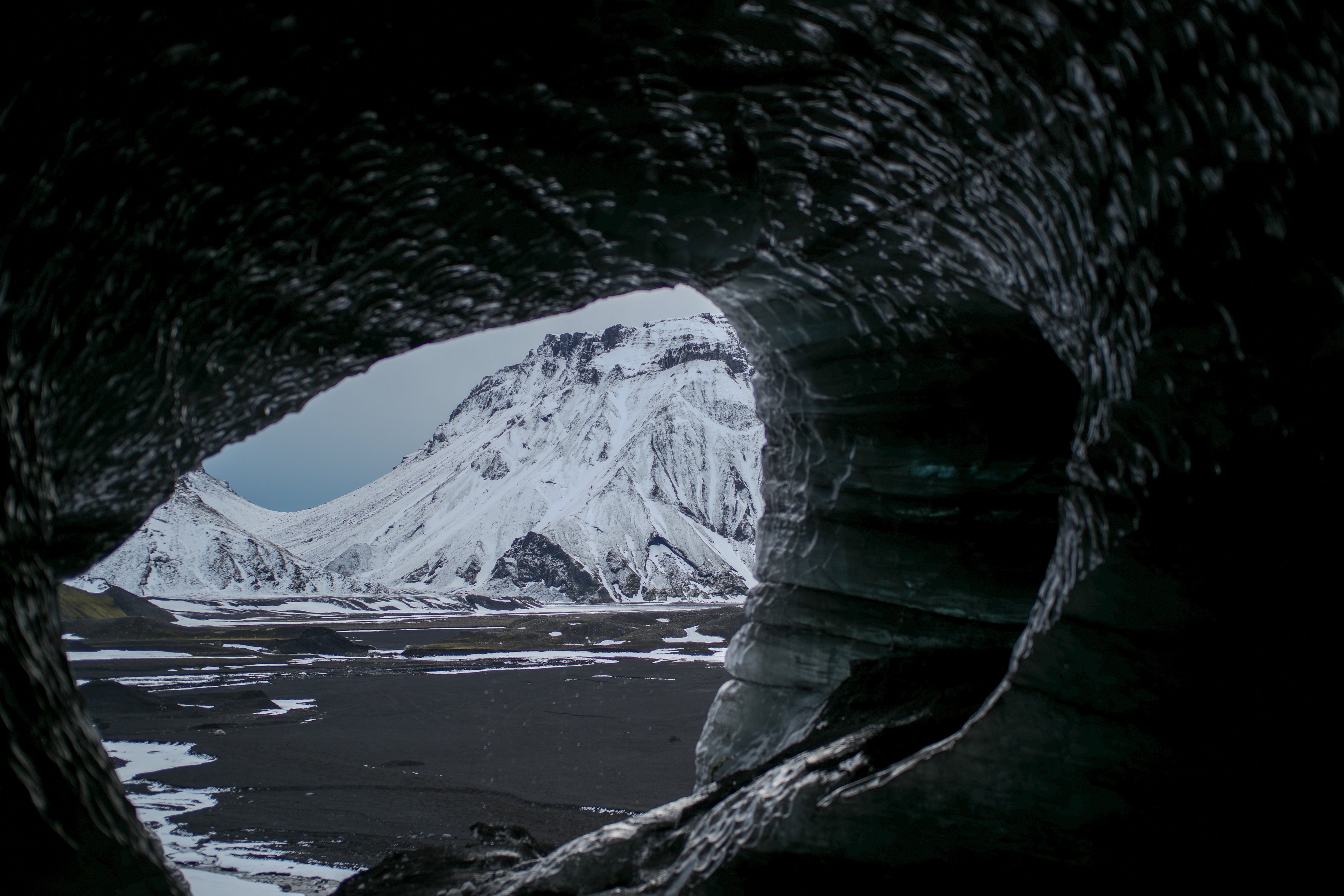 Ice Cave Window to a Snowy Peak - Iceland Landscape Photography
