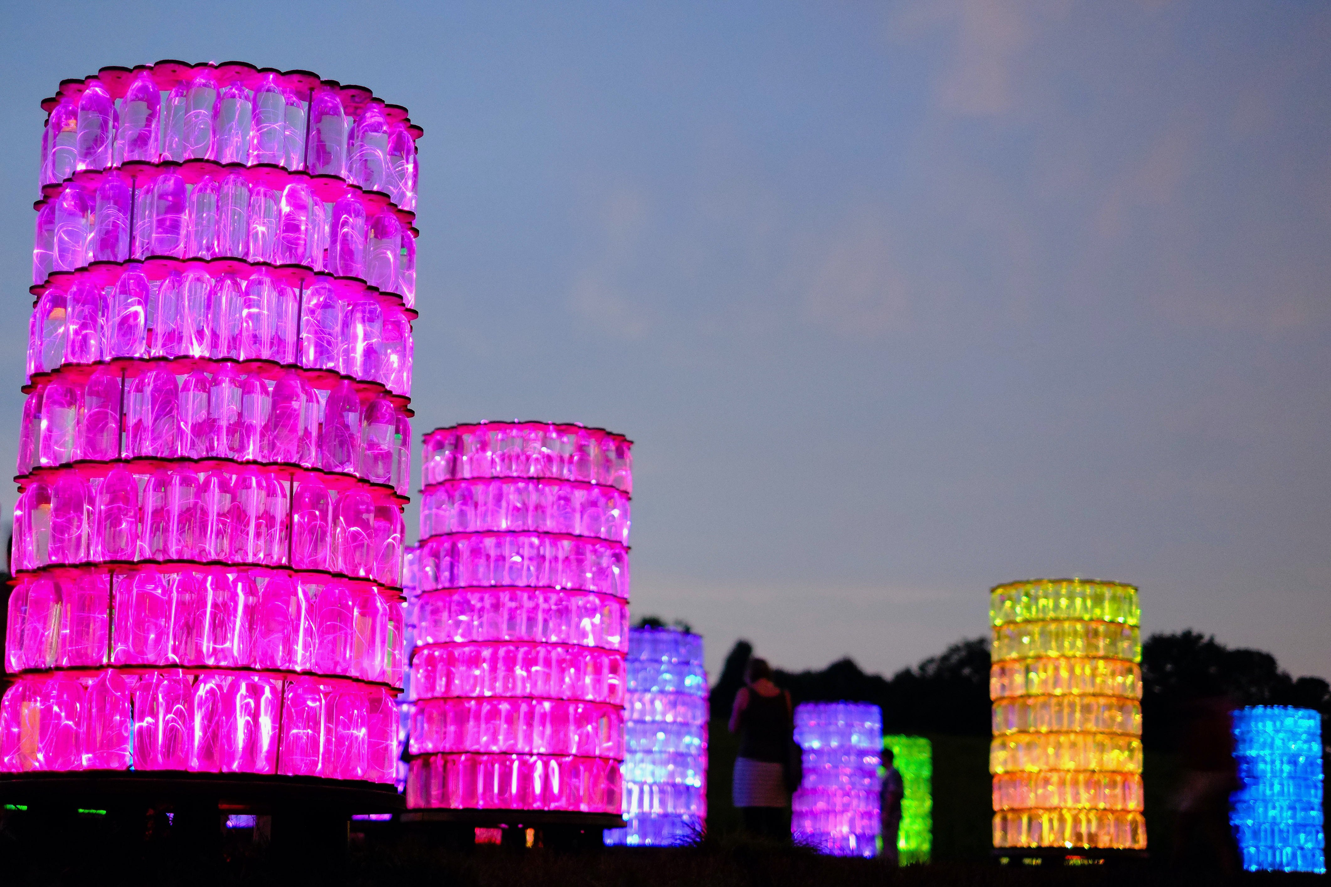 Illuminated Bottle Towers - Night Light Installation Photography
