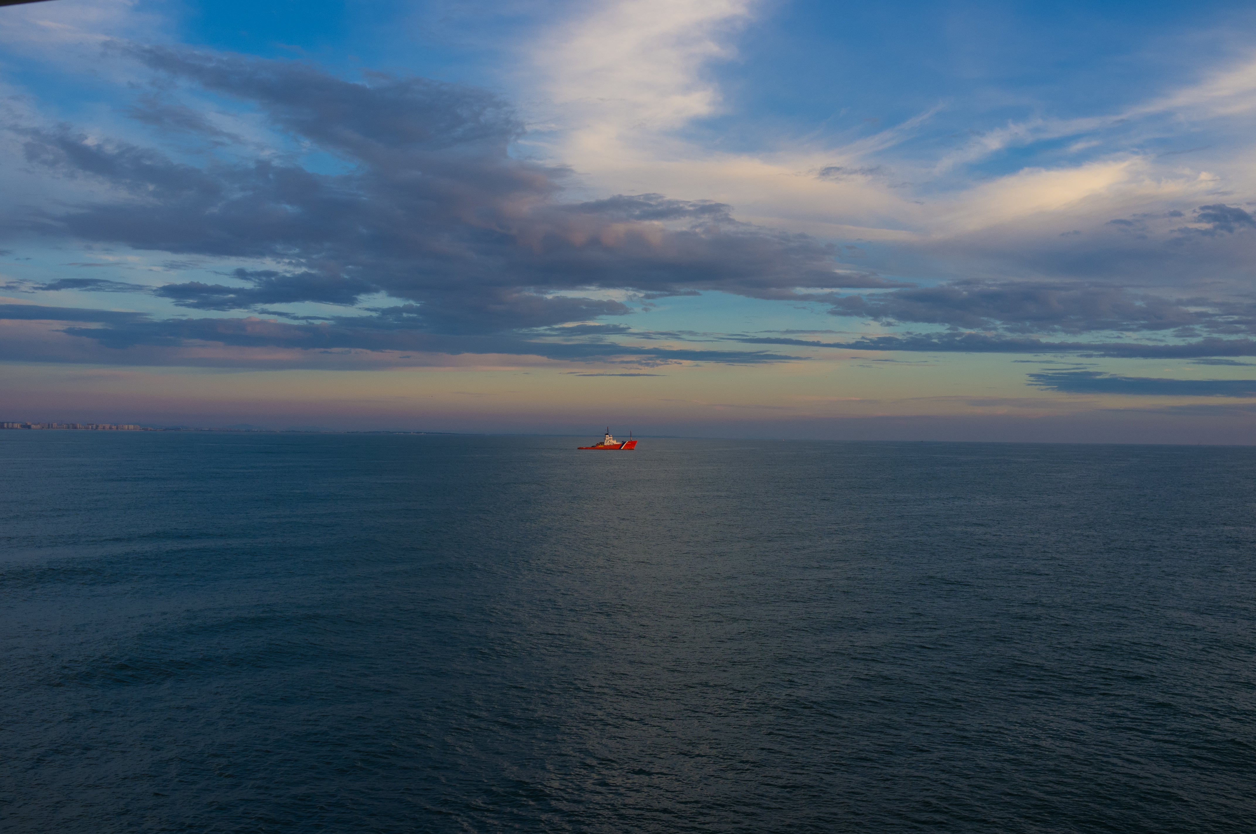 Red Ship at Sunset - Open Ocean Maritime Photography
